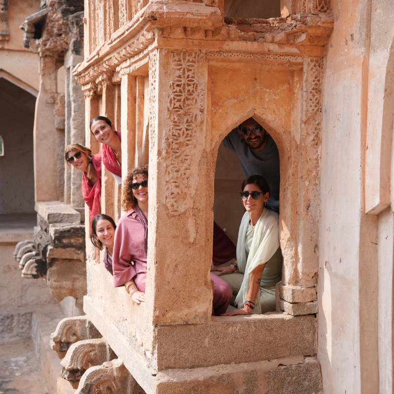 Grupo del retiro de yoga en India explorando los monumentos históricos de Hampi